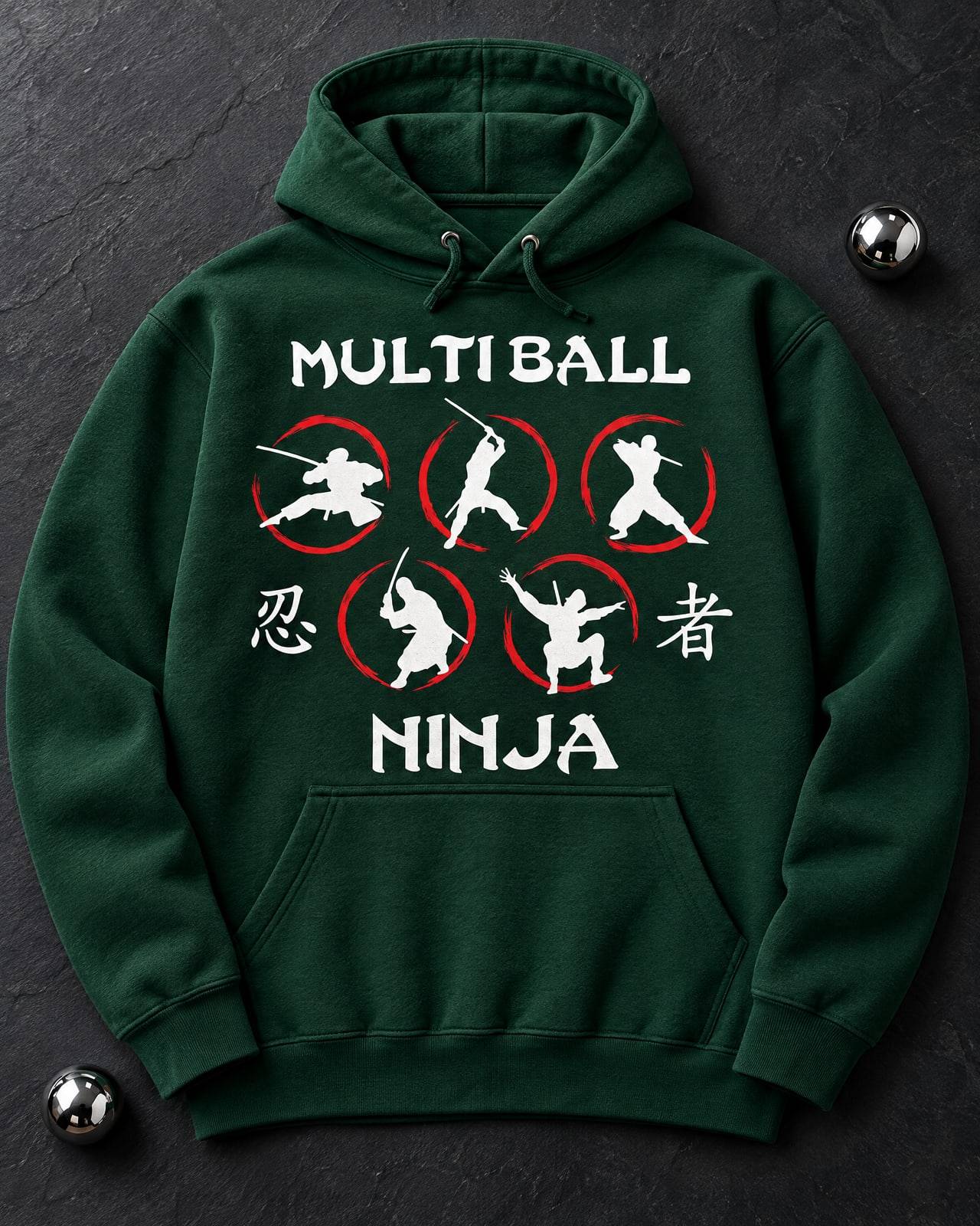Concept mockup of a deep forest green hoodie laid flat on slate with the full Multiball Ninja logo printed large across the chest